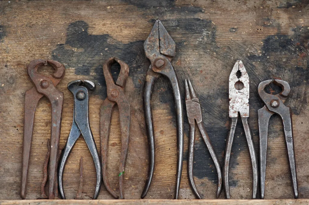 Different Types of Antique Pliers on Table