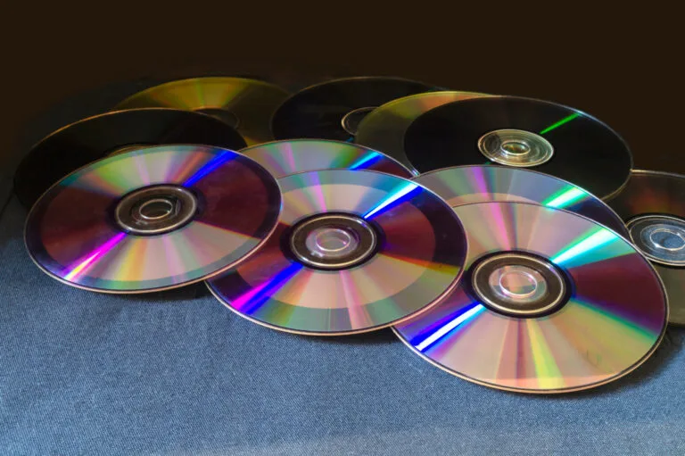 A Group of Shiny Old CDs on a Table