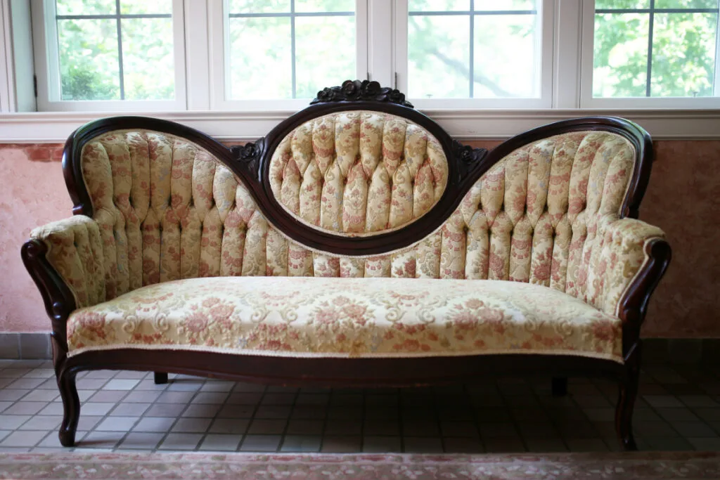 An old, 1800s Sofa with Tufted Backs